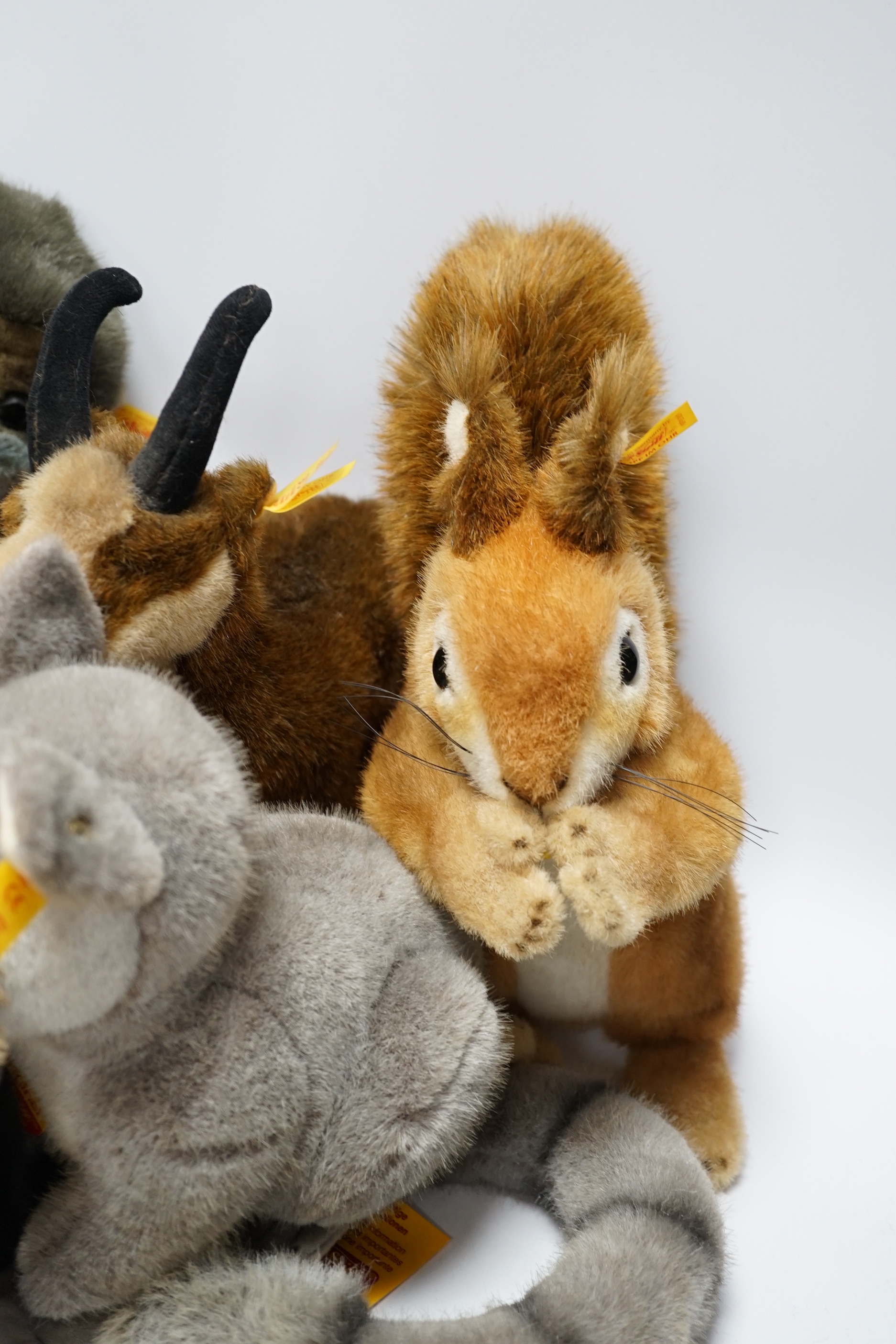 Thirteen Steiff yellow tag animals and one yellow tag bear, including Snorry fox, Mannie rabbit, Nagy beaver and Resi cow